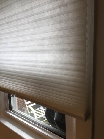 reviewer's photo of the cordless window shades rolled partially up