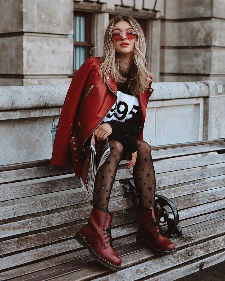 a model posing in the burgundy boots