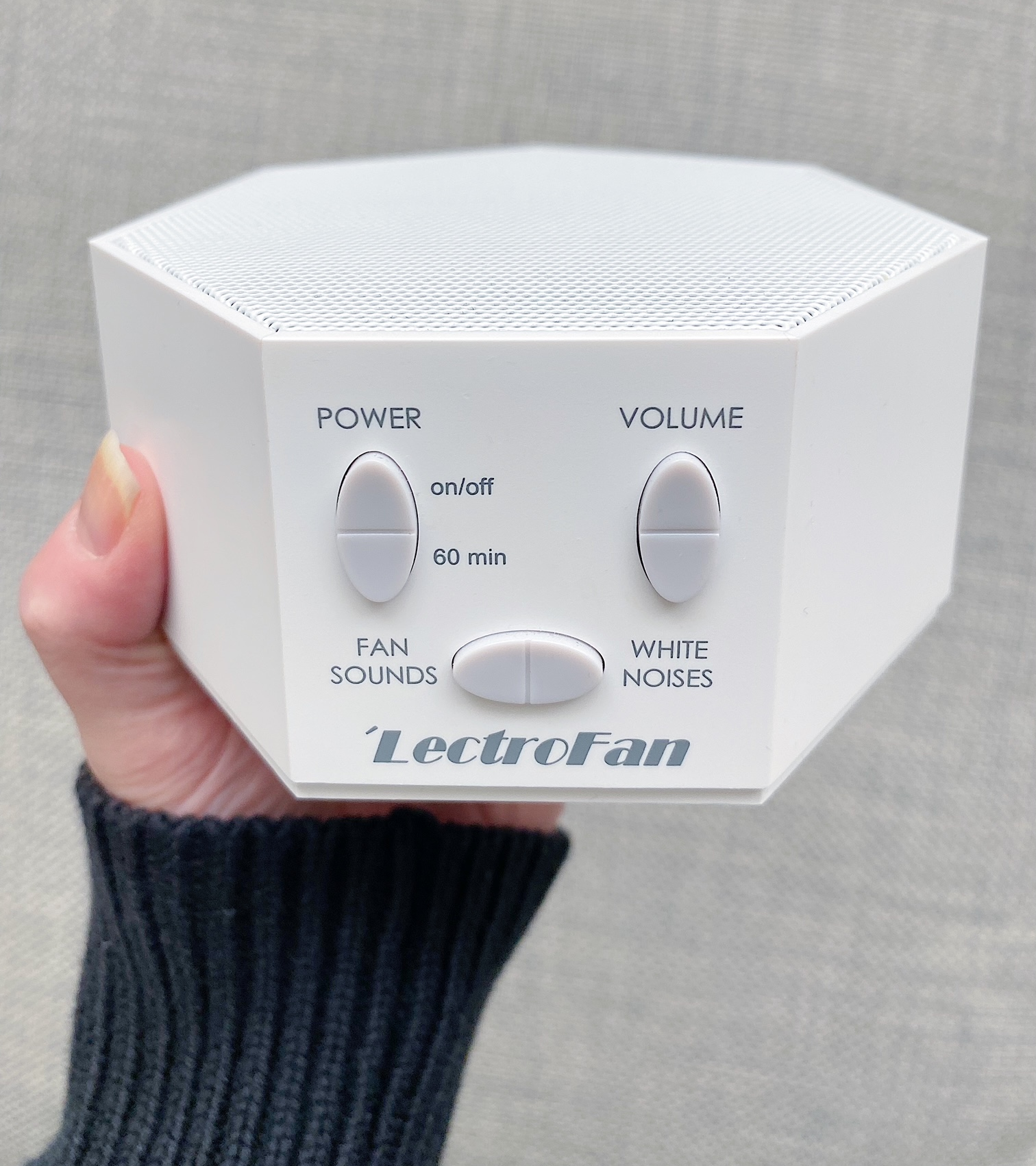 BuzzFeeder holding the white noise machine