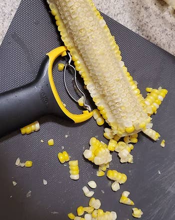 reviewer photo of an ear of corn that's had half of its kernels stripped away using the peeler