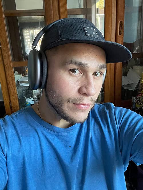 Reviewer wearing the headphones in grey
