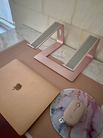 reviewer's pink laptop stand