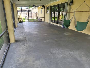 reviewer's patio with a patchy gray concrete floor