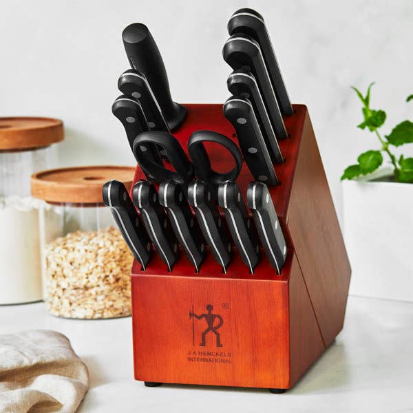 Knife artifact  acceptable   with aggregate  knives organized neatly, assorted  sizes and styles, displayed connected  a room  antagonistic  with adjacent    jars and plants
