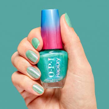 Hand holding OPI RapiDry nail polish vessel  