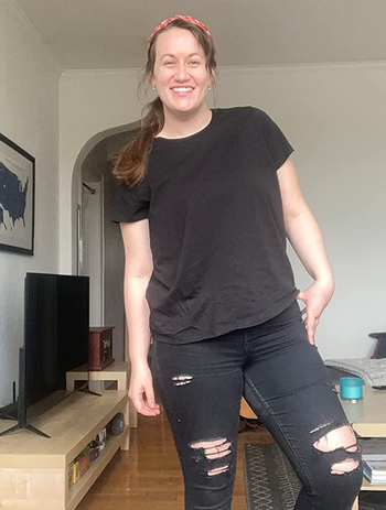 a reviewer wearing the T-shirt in black 