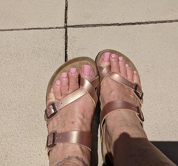 a reviewer wearing the shoes in rose gold tone 