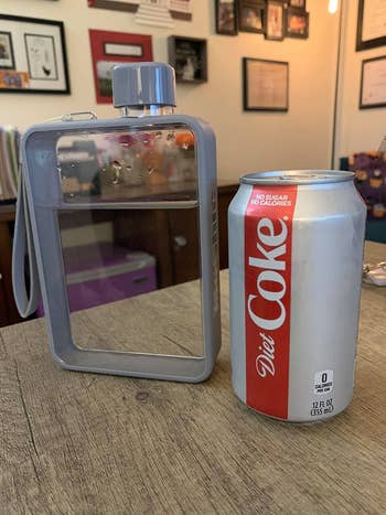 clear compact rectangle-shaped water bottle filled with water on table