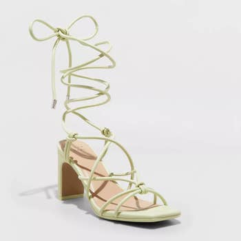 Block heels with adjustable straps in the color lime green. 