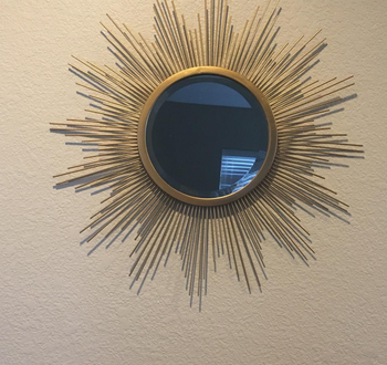 a reviewer photo of the mirror hung on the wall 