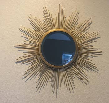 a reviewer photo of the mirror hung on the wall 