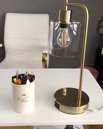 reviewer's gold lamp on desk