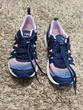a pair of the sneakers in navy blue and light purple 