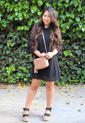 reviewer in a black lace sleeve midi dress