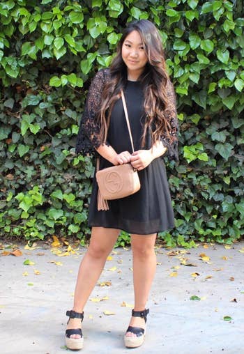 reviewer in a black lace sleeve midi dress 