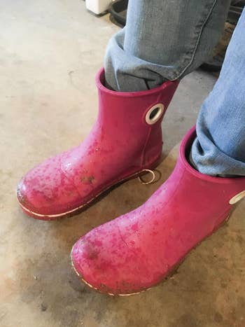 reviewer photo wearing hot pink Crocs boots