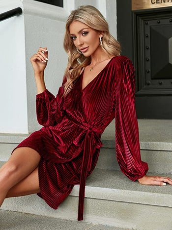 Model is wearing the burgundy velvet ribbed long sleeve dress