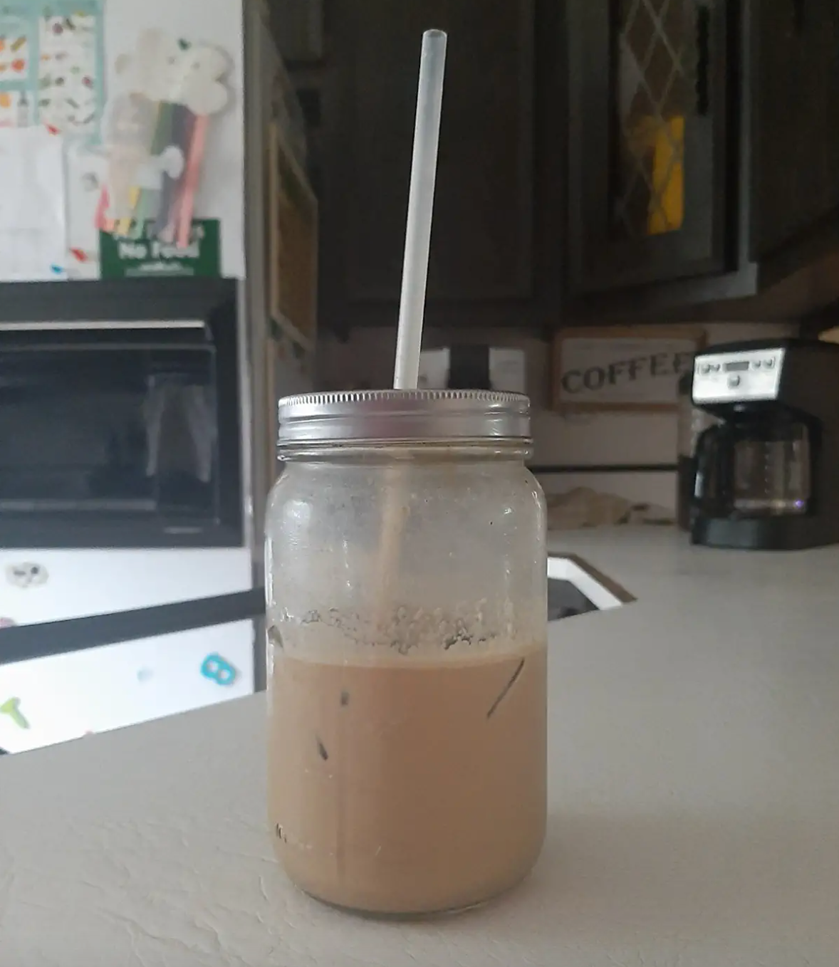 A reviewer's straw in a mason jar iced coffee