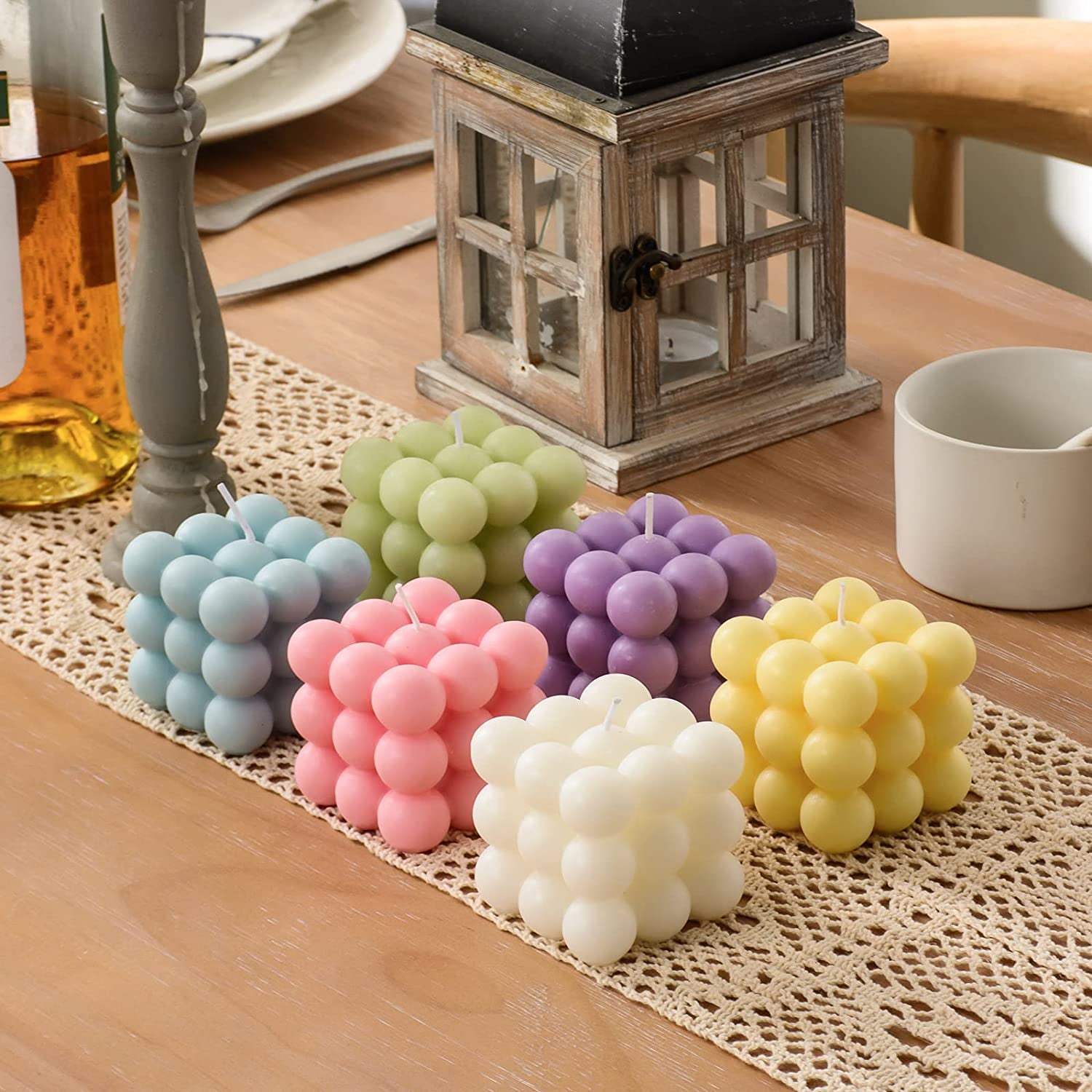 six bubble cube candles in blue, pink, white, yellow, purple, and green