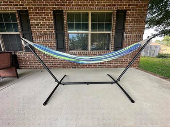 Hammock connected a metallic basal acceptable up connected a patio successful beforehand of a ceramic location with ample windows. Ideal for outdoor relaxation