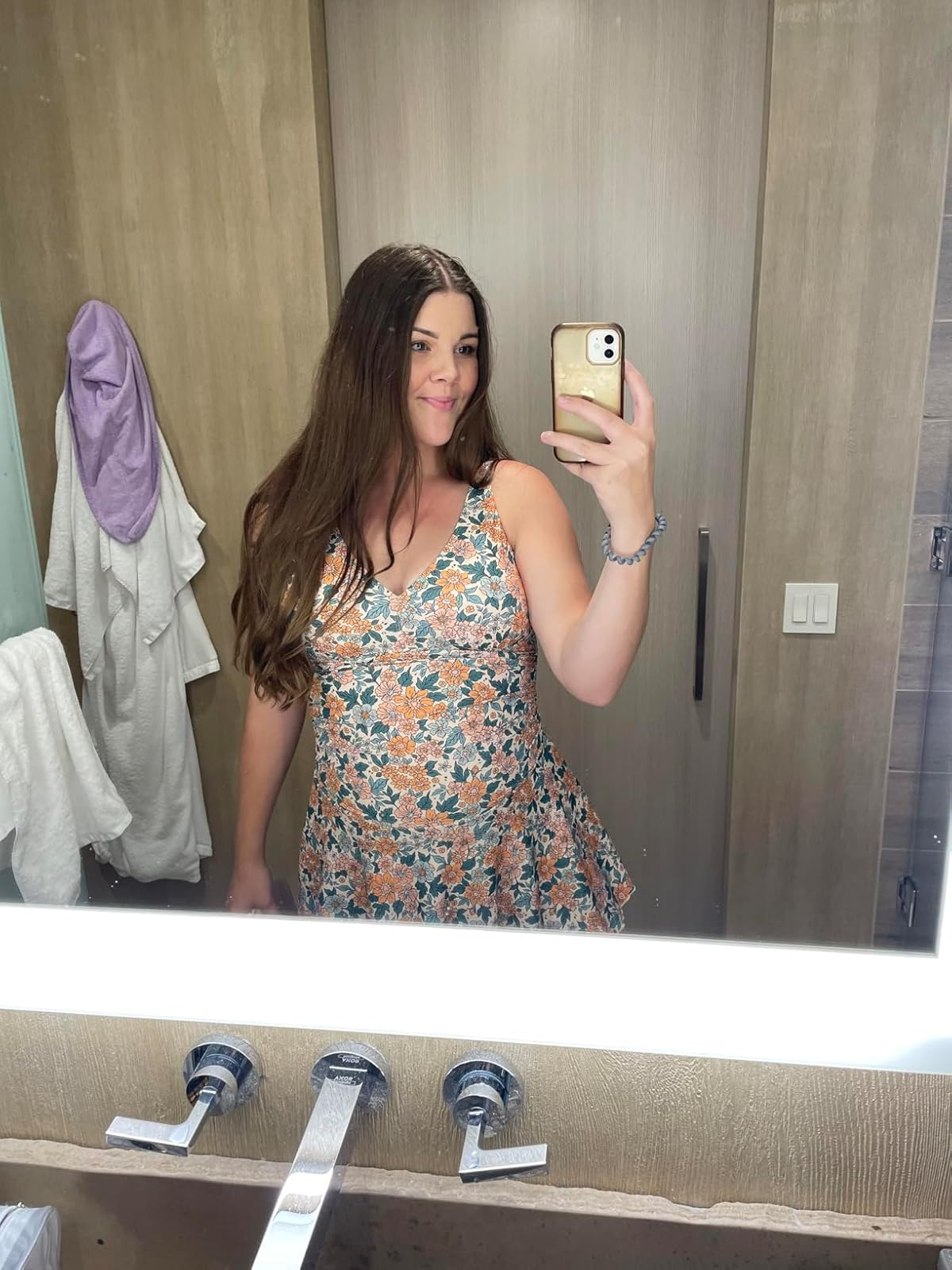 reviewer wearing the floral swimdress