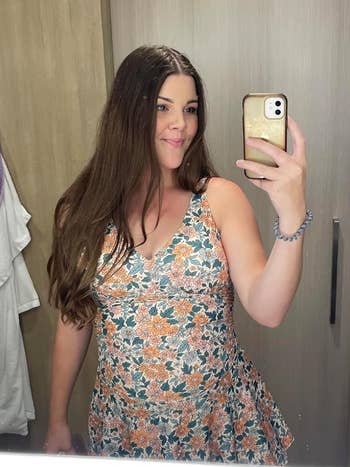 reviewer wearing the floral swimdress