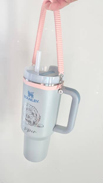 Stanley travel mug with handle and straw, featuring a dog design and the name 'Kopper' on it