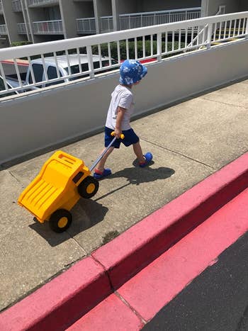 A child pulling the monster truck luggage
