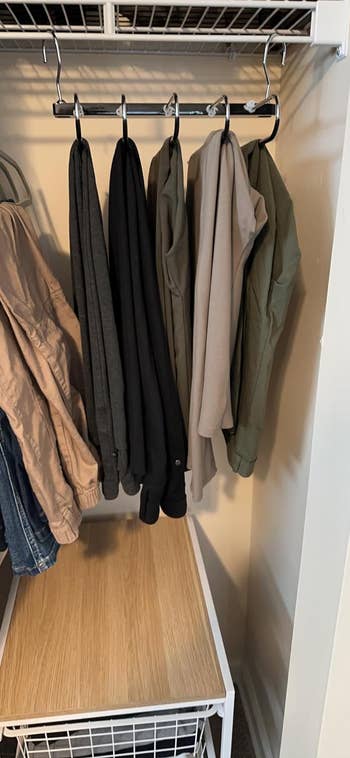 a reviewer's hanger expanded showing that it holds multiple pairs of pants