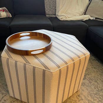 reviewer photo of the ottoman with tray on it