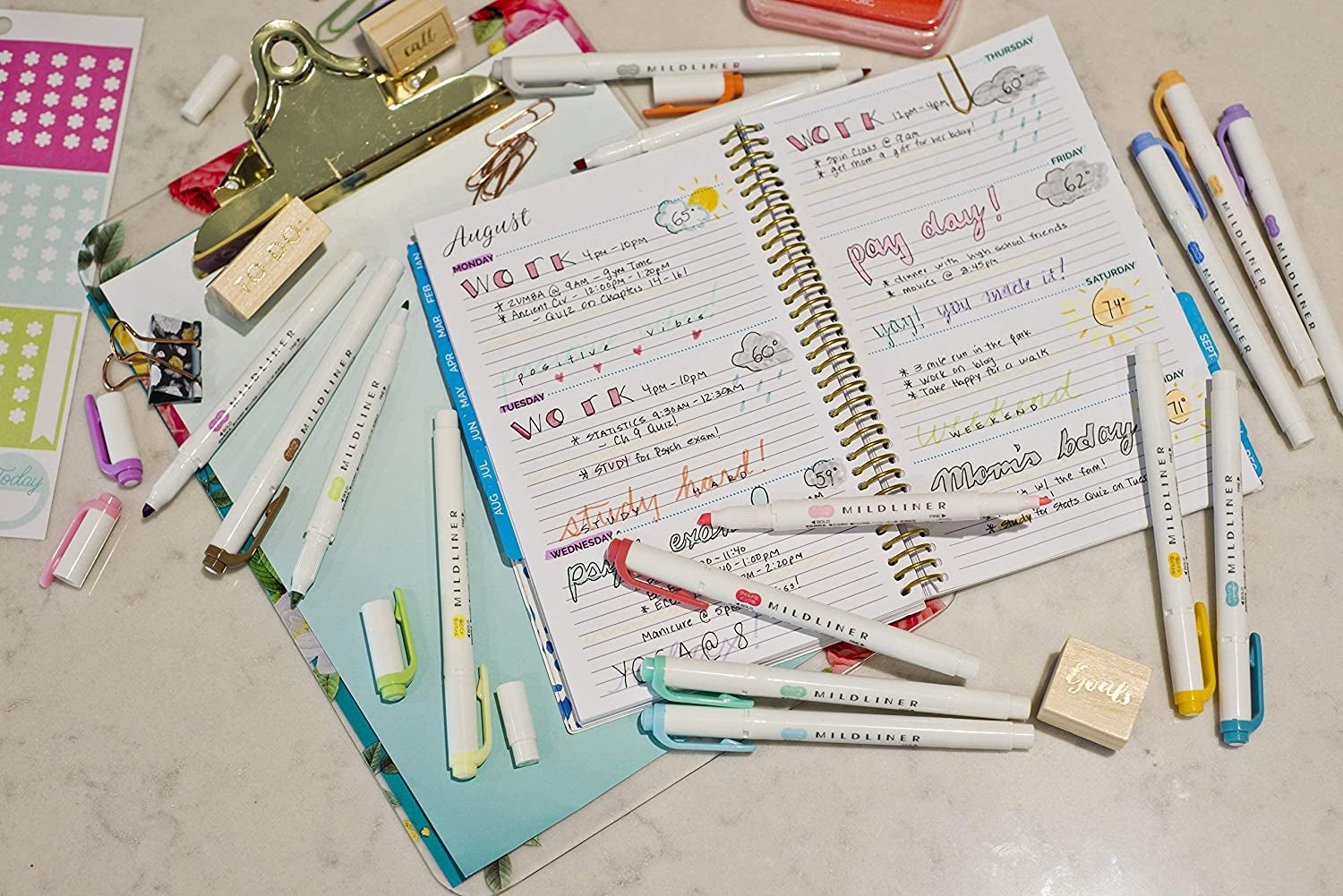 various midliner highlighters next to a notebook