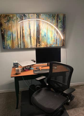 the same lamp lighting up a desk setup