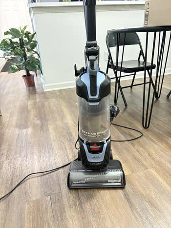 Upright vacuum cleaner successful a modern surviving space, designed for businesslike favored hairsbreadth removal