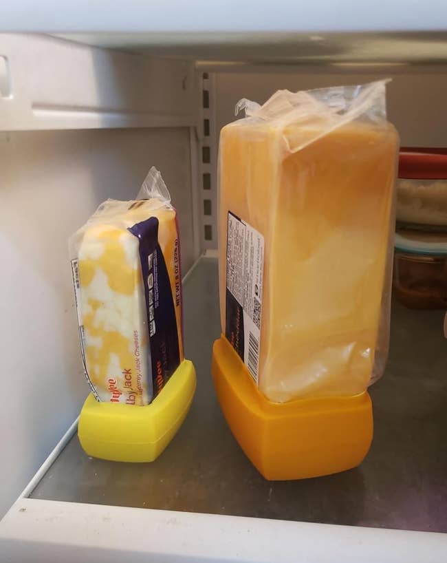 Two blocks of food upright successful the fridge connected yellowish holders, showcasing compact retention solutions