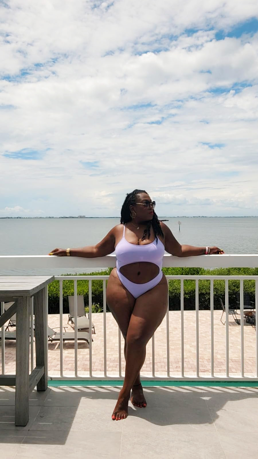 reviewer posing in the purple monokini