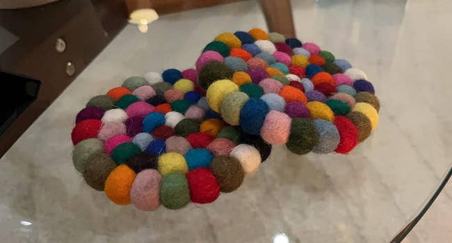 reviewer image of two of the colorful wool round coasters