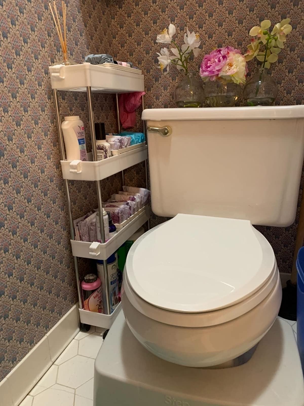 Reviewer photo of the cart filled with toiletries next to a toilet