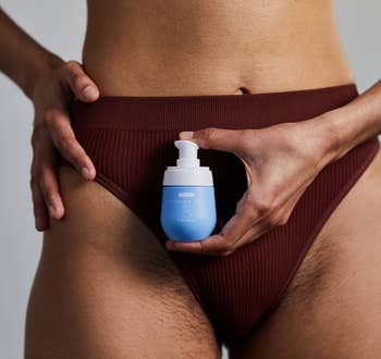 Person in underwear holding a skincare product for ingrown hair near groin 