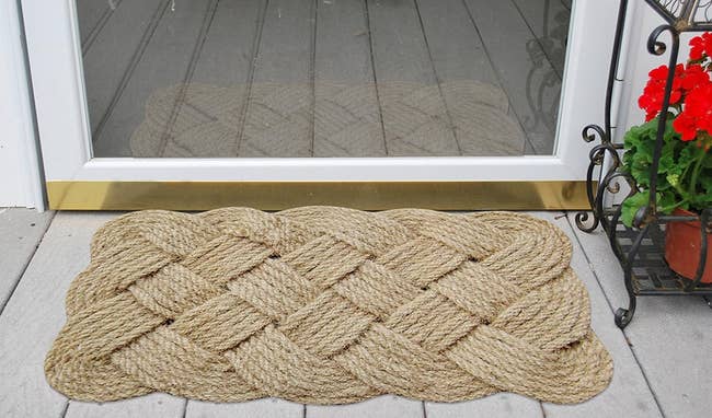 woven door mat outside of a glass door