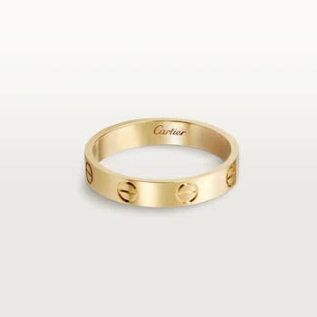 a gold cartier love band ring