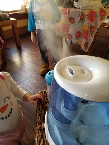 Children playing adjacent   a steam humidifier wrong  a cozy room