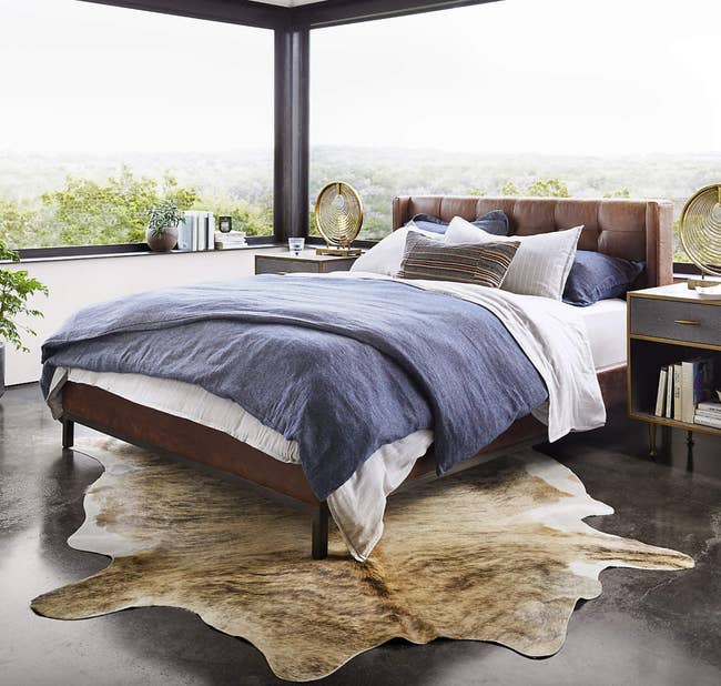 leather platform bed in a sunlit bedroom