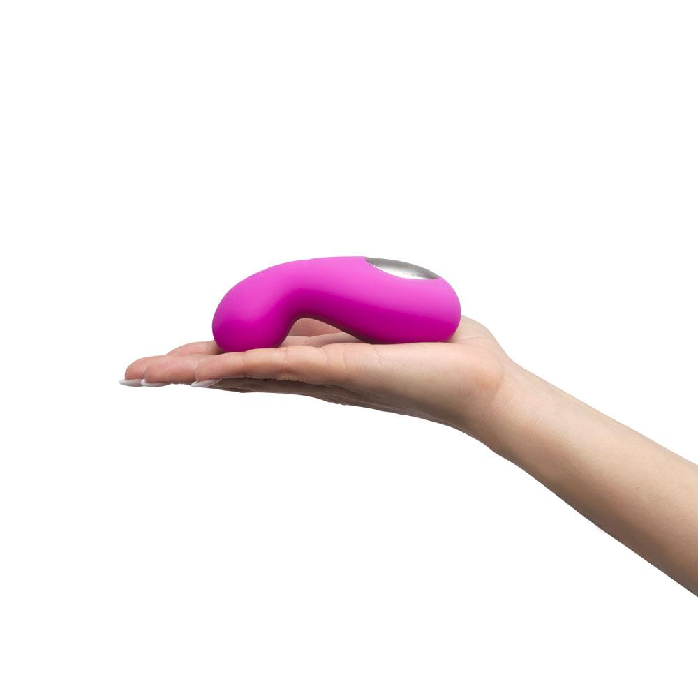 Model holding vibrator flat on palm