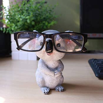 glasses holder shaped like a koala; glasses sit on koala's face like he's wearing them