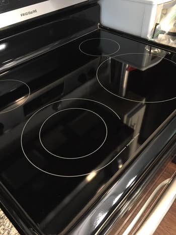 on right: same glass cooktop without the burned-on residue after reviewer used the cooktop-cleaning kit to remove it
