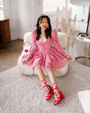 model wearing the socks with red heels and a pink dress