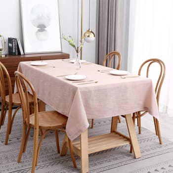 pink faux linen table cloth on a four-seater table