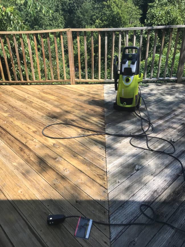 reviewer photo showing the pressure washer with one side of a freshly cleaned wooden deck and the other side dirty and grimy for comparison