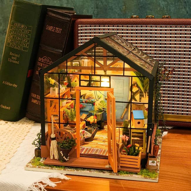 a constructed miniature greenhouse 