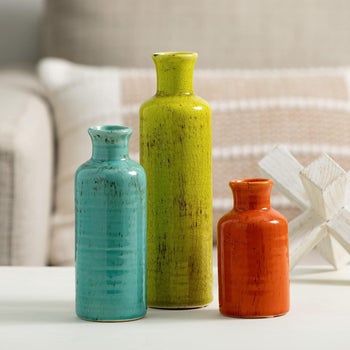Same set in orange, blue, and green vases 
